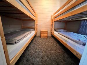 two bunk beds are in a room with at Domki Sosnówka-Kaszuby in Zgorzałe