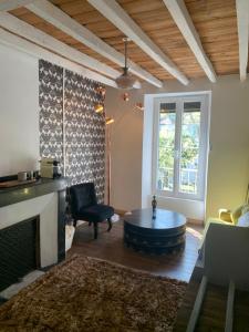 a living room with a couch and a coffee table at Chambres d hôtes H in Lavelanet