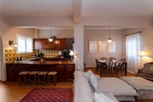 a living room and kitchen with a couch and a table at FantaSea Evgenia in Sampatiki