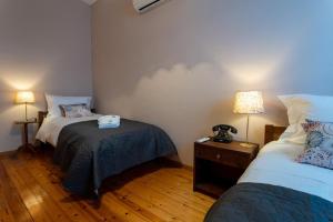a room with two beds and a table and two lamps at FantaSea Evgenia in Sampatiki