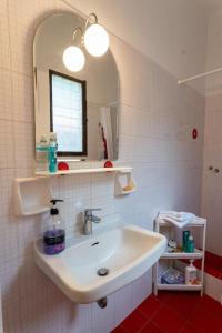 a bathroom with a sink and a mirror at FantaSea Evgenia in Sampatiki +24 photos