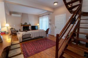 a living room with a bed and a staircase at FantaSea Evgenia in Sampatiki