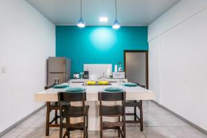 a kitchen with a table and four chairs at Cahuita Apartment by Angie in Cahuita +16 photos