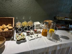 a table with a white table cloth with food on it at Voigt's Hofpension GbR in Zahna-Elster