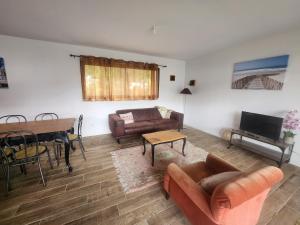 a living room with a couch and a table at Maison centre-ville , pisicne in Mimizan