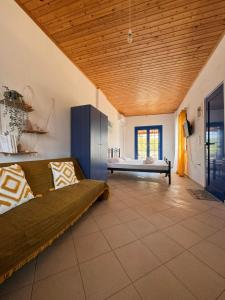 a large living room with a couch and a bed at LifeHouse in Agia Pelagia
