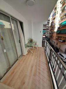 a room with a balcony with a table on the floor at Alojamiento El Sevillano in Cullera
