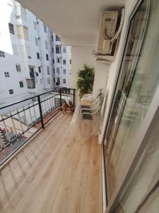 a balcony with a wooden floor in a apartment at Alojamiento El Sevillano in Cullera