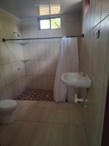 a bathroom with a sink and a toilet at Mandy's Villa in Bluefields