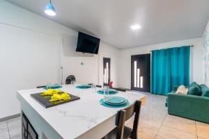 a kitchen and living room with a table and a couch at Cahuita Apartment by Angie in Cahuita