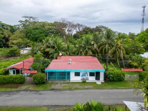 a small house with a red roof at Cahuita Apartment by Angie in Cahuita
