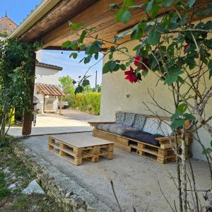 a couch and a coffee table on a patio at La bâtisse a deux tours in Lalbenque