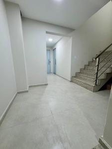 an empty hallway with stairs in a building at No centro, em frente à praça in Eunápolis +5 photos