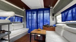 a living room with blue curtains and a couch at Confortable Yatch in Barcelona