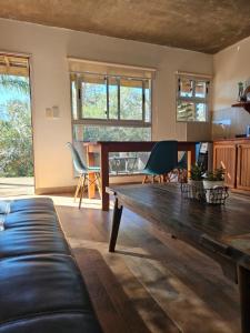 a living room with a couch and a wooden table at MarEz in Punta Del Diablo