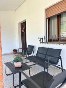 two chairs and a table on a patio at AlMi House - Colline del Prosecco in Soligo