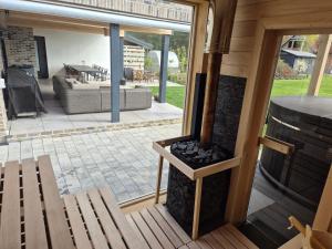 a view of a patio from a house with a fireplace at Willa nad Jagodnym in Kozin