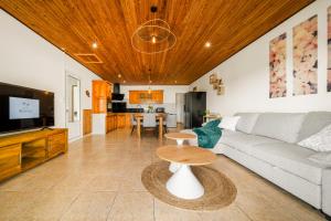 a living room with a couch and a table at Villa BELLEVUE in Bras-Panon