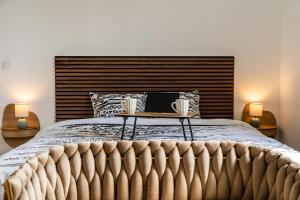 a bedroom with a bed with a laptop on a table at Villa BELLEVUE in Bras-Panon
