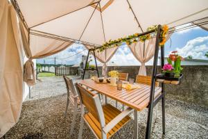 a table in a tent with chairs and flowers at Villa BELLEVUE in Bras-Panon