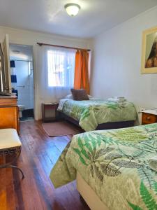 a hotel room with two beds and a window at Donde Mauricio in Coihaique