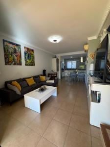 a living room with a couch and a table at Villa Feliz 44 in Meloneras