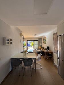 a kitchen and living room with a table and chairs at Villa Feliz 44 in Meloneras