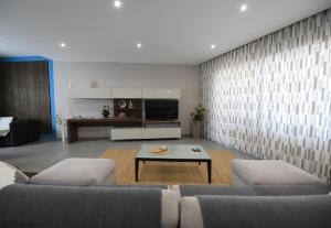 a living room with a couch and a coffee table at Hal Saghtrija - Gozo Hideaways in Żebbuġ +35 photos
