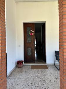 an open door of a house with a flower pot at AlMi House - Colline del Prosecco in Soligo