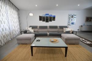 a living room with a couch and a coffee table at Hal Saghtrija - Gozo Hideaways in Żebbuġ