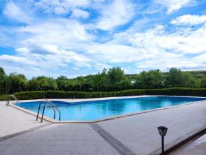 a large swimming pool with blue water at Nelly's Place 27 in Shkorpilovtsi