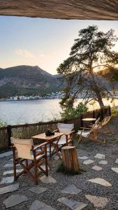 a picnic table and chairs next to a lake at MonemBlue in Monemvasia