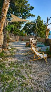 a table and chairs sitting on a beach with a tent at MonemBlue in Monemvasia