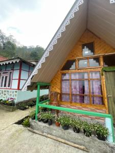 a house with a bench in front of it at Golays homestay in Kalimpong