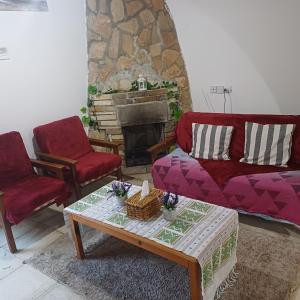 a living room with a couch and two chairs and a table at Vocation Rest House in Anogyra in Anoyira