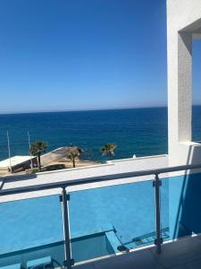 a view of the ocean from the balcony of a building at Apartmani Vila Delfin in Dobra Voda
