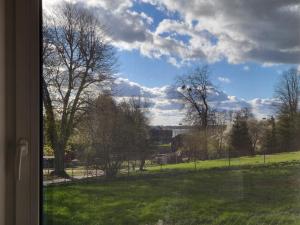 a view from a window of a field with trees at Apartament Harsz in Harsz