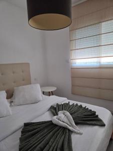 a room with a bed with a towel on it at Casa Ghjuvanna in Propriano