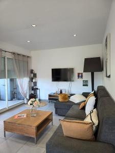 a living room with a couch and a coffee table at Casa Ghjuvanna in Propriano