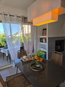 a kitchen with a table with flowers on it at Casa Ghjuvanna in Propriano