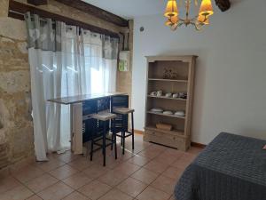 a kitchen with a table and chairs in a room at Logis du Bourg in Puy-lʼÉvêque
