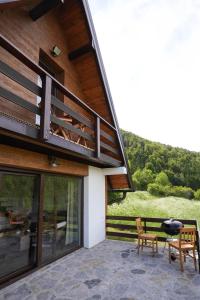 a house with a patio with a table and two chairs at Josahouse in Bjeluša
