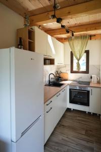 a kitchen with white appliances and a white refrigerator at Josahouse in Bjeluša