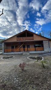 a large building with a large roof at racha cozy cottage in Ambrolauri