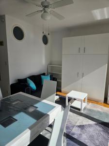 a living room with a table and a couch at Port Dienville in Montfort-lʼAmaury +4 photos