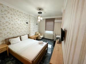 a bedroom with a bed and a tv in it at Safir Hotels Silivri in Silivri