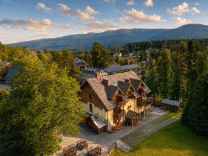 an aerial view of a house with mountains in the background at Domki - Pod Smerkami in Szklarska Poręba