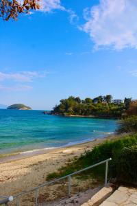 a beach with an island in the water at Riviera Penthouse in Paleo Tsifliki +6 photos