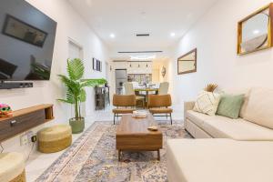 a living room with a couch and a table at 2BDR Condo Beach Downtown Jacuzzi Pool Amenities in Cabo San Lucas