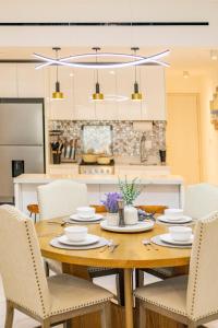 a dining room with a wooden table and chairs at 2BDR Condo Beach Downtown Jacuzzi Pool Amenities in Cabo San Lucas